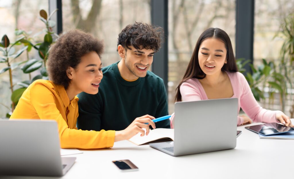 three marketing students with laptop